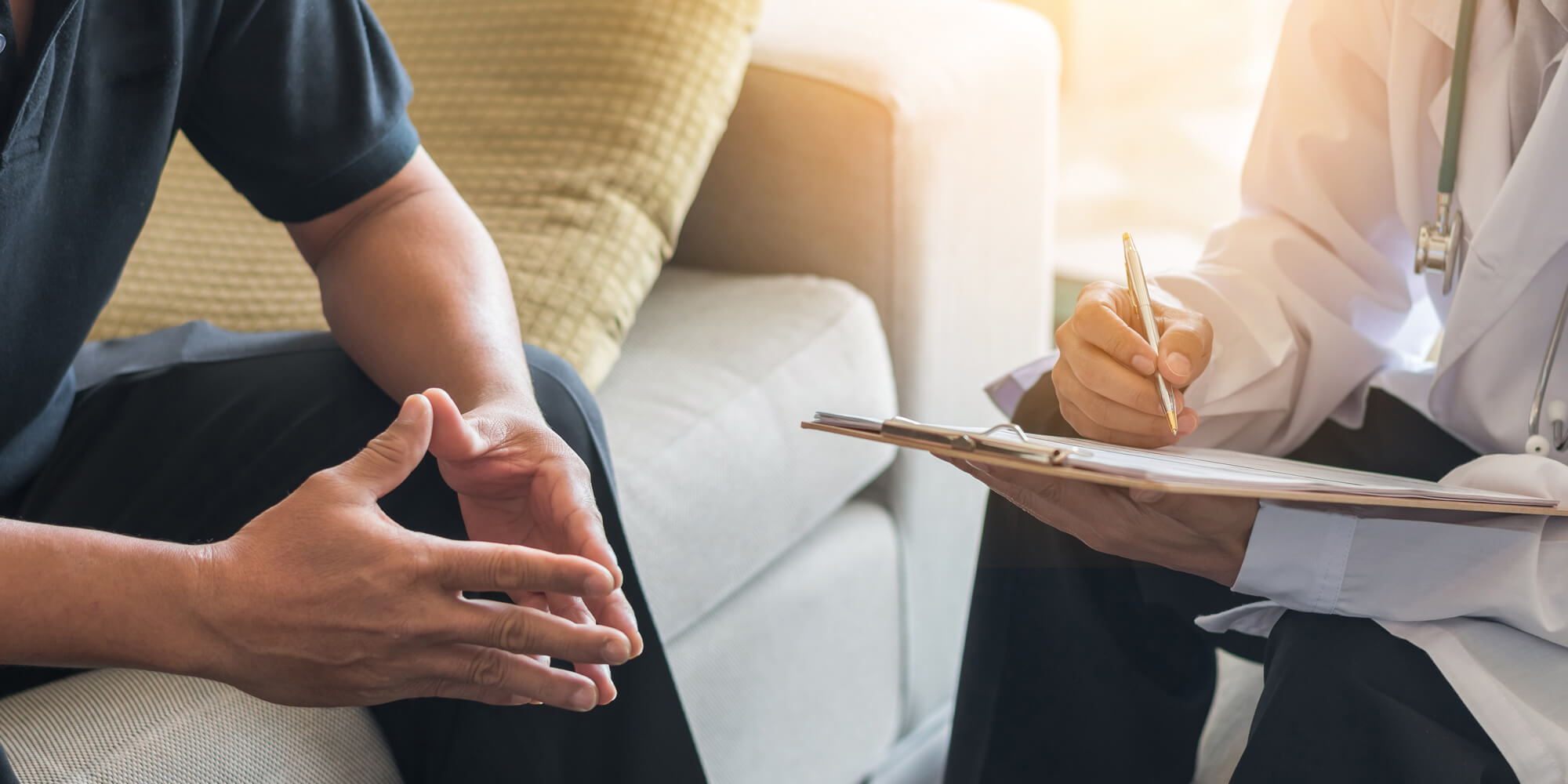 Doctor speaking with man on a couch