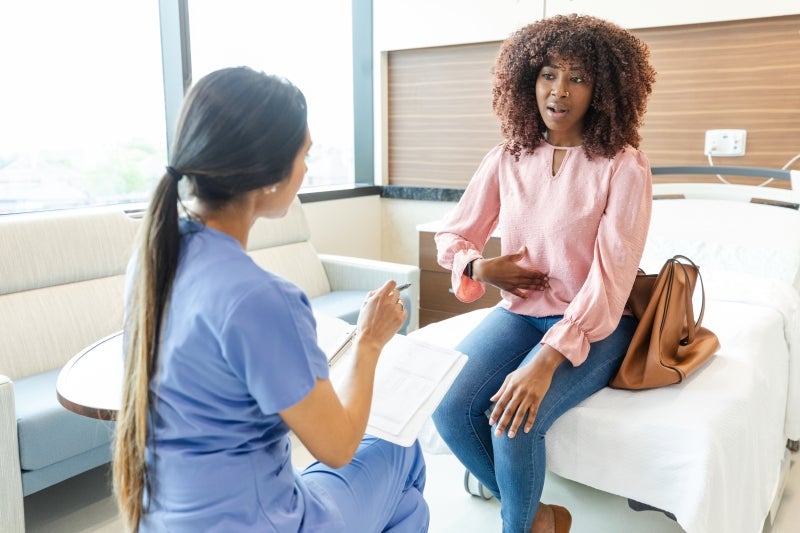 Woman working with her physician to take control of her digestive health