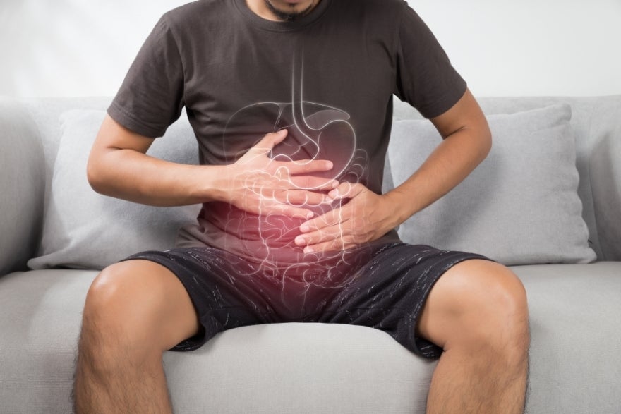 Man holding stomach in pain