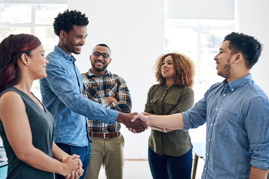 Group of new hires greeting each other