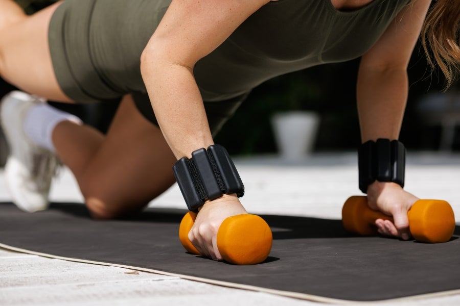 Woman exercising using weights