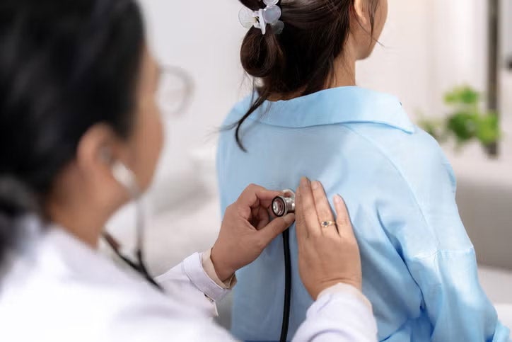 Doctor examining patient with stethoscope
