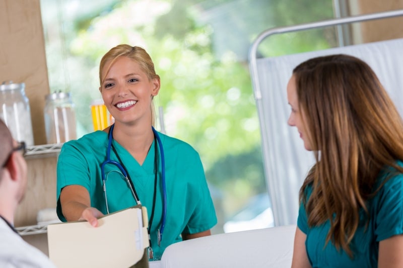 Medical assistant working with other staff on a project