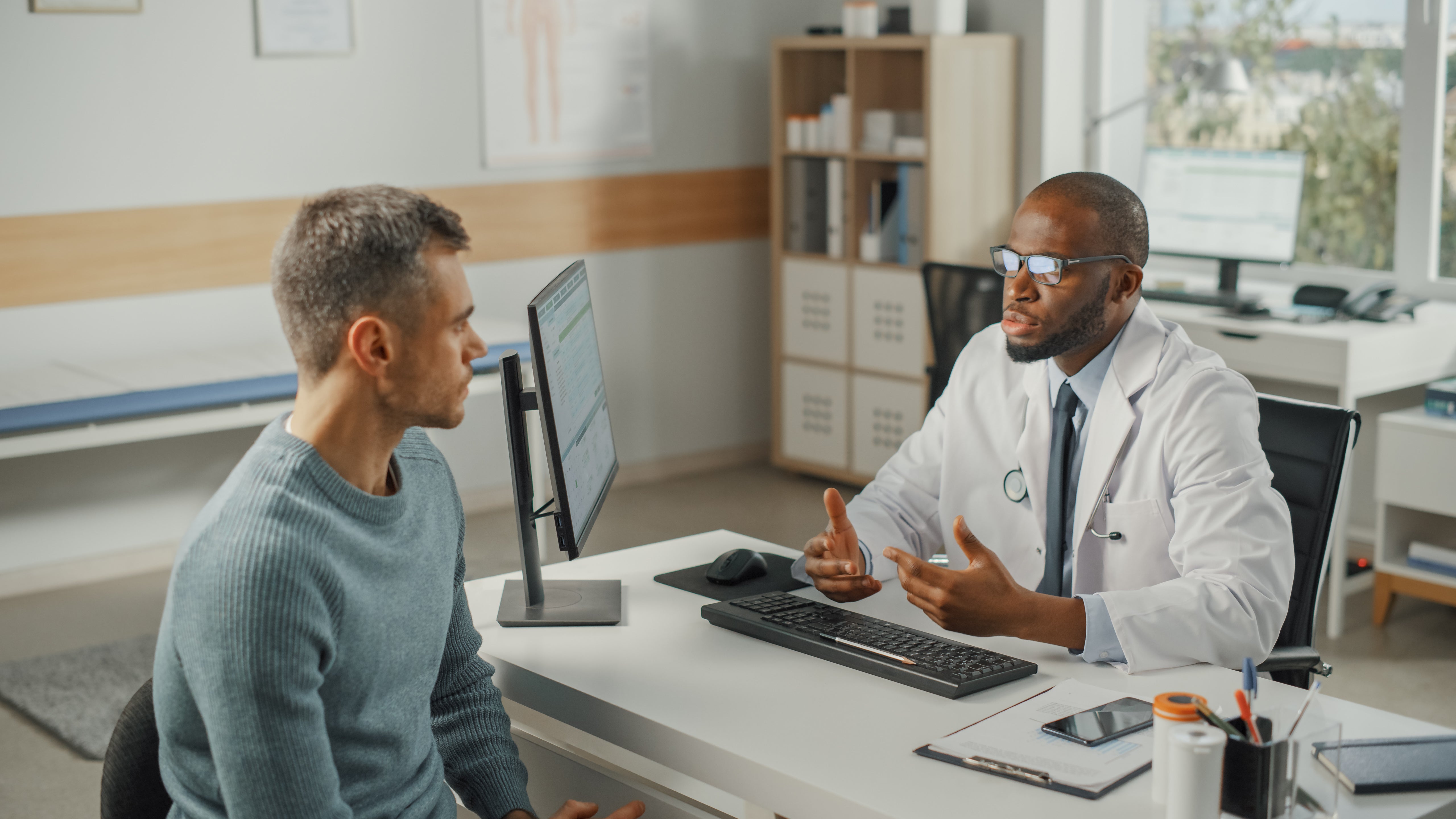 A man confers with his doctor about his ED symptoms