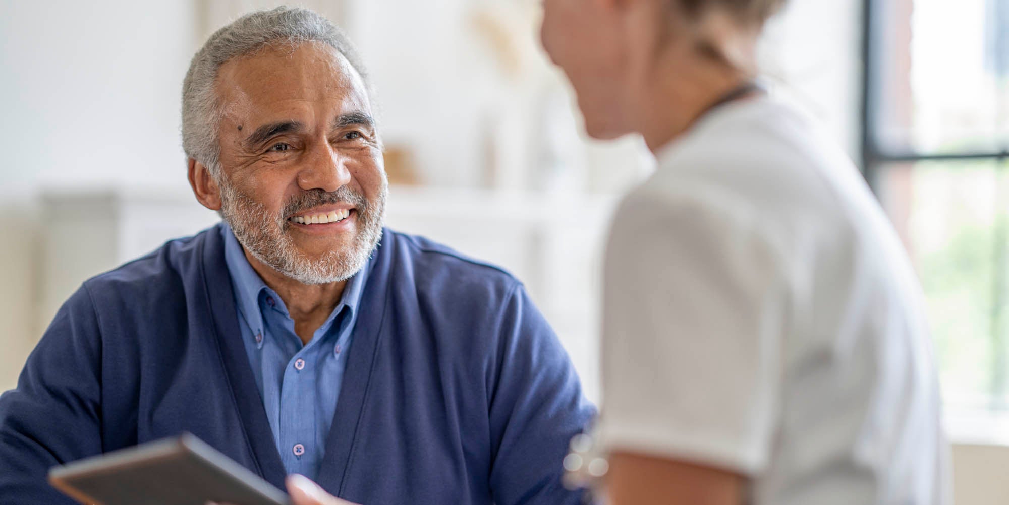 Patient smiling talking to his doctor