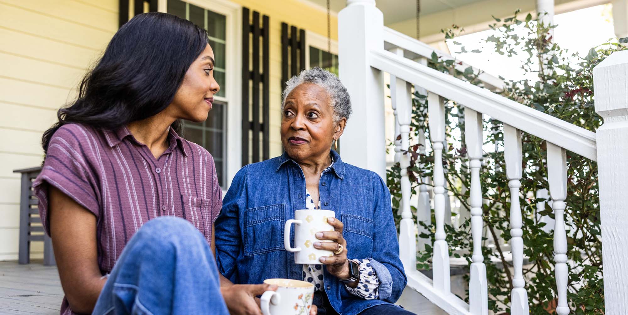 Mother and daughter drinking coffee together