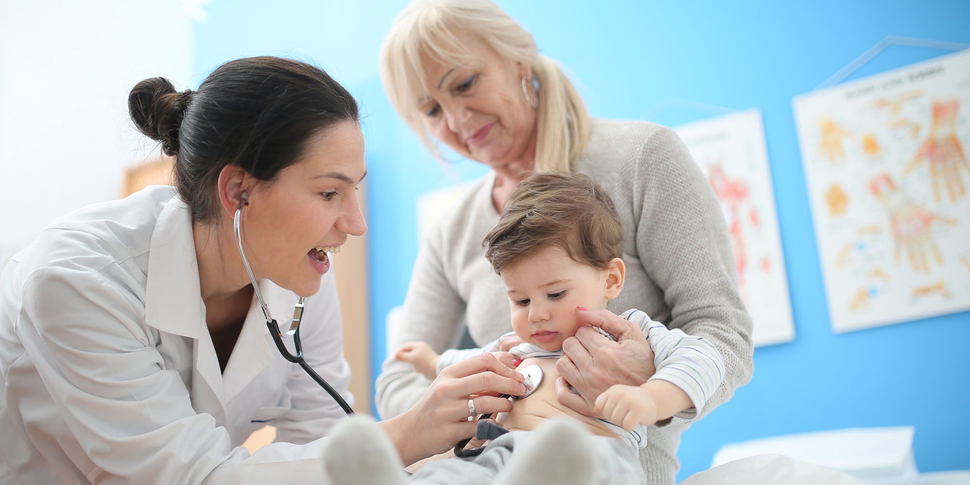 Doctor checking child's heart beat