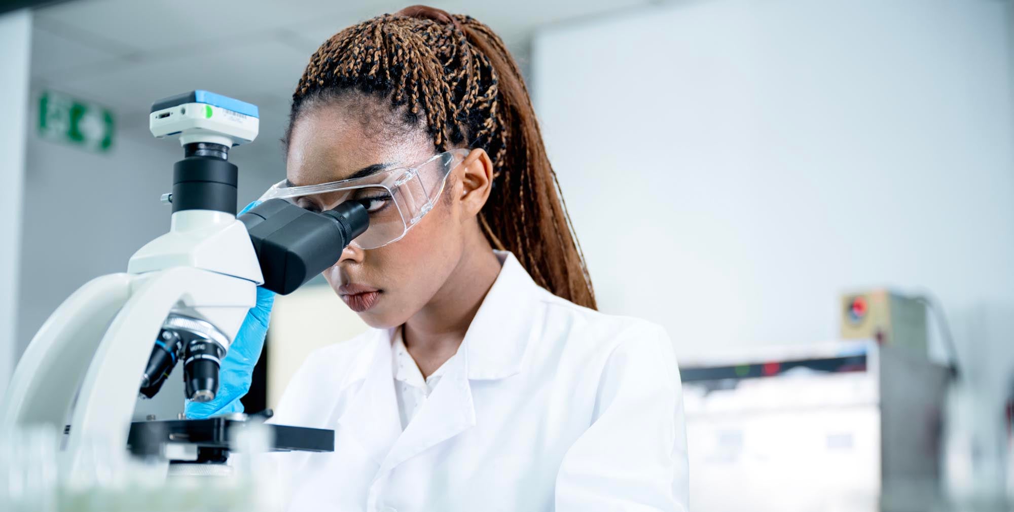 Physician looking into a microscope